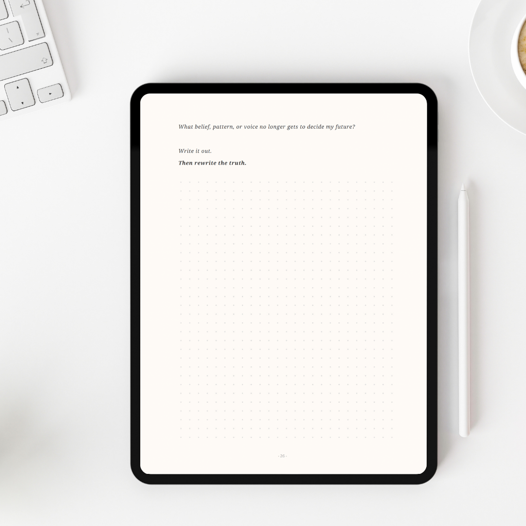 Digital tablet displaying text on a white desk with a keyboard and mug.